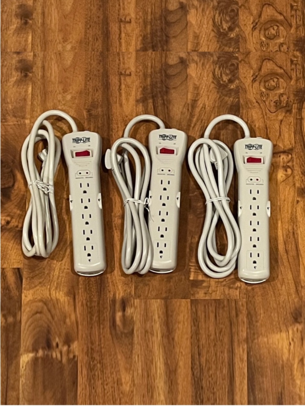 Three (3): Tripp Lite - 7 Outlet Surge Protector Power Strips - Model: SUPER7